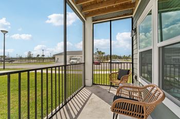 A balcony with a chair and a table.